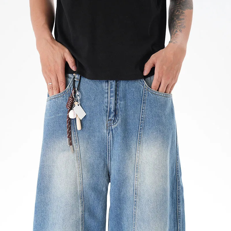 Cut washed vintage washed wide leg machete jeans in light blue denim with zipper fly, front view
