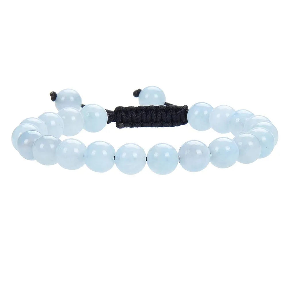 Women's flat knot braided healing bracelet with natural aquamarine stone, hand-woven geometric design on white background