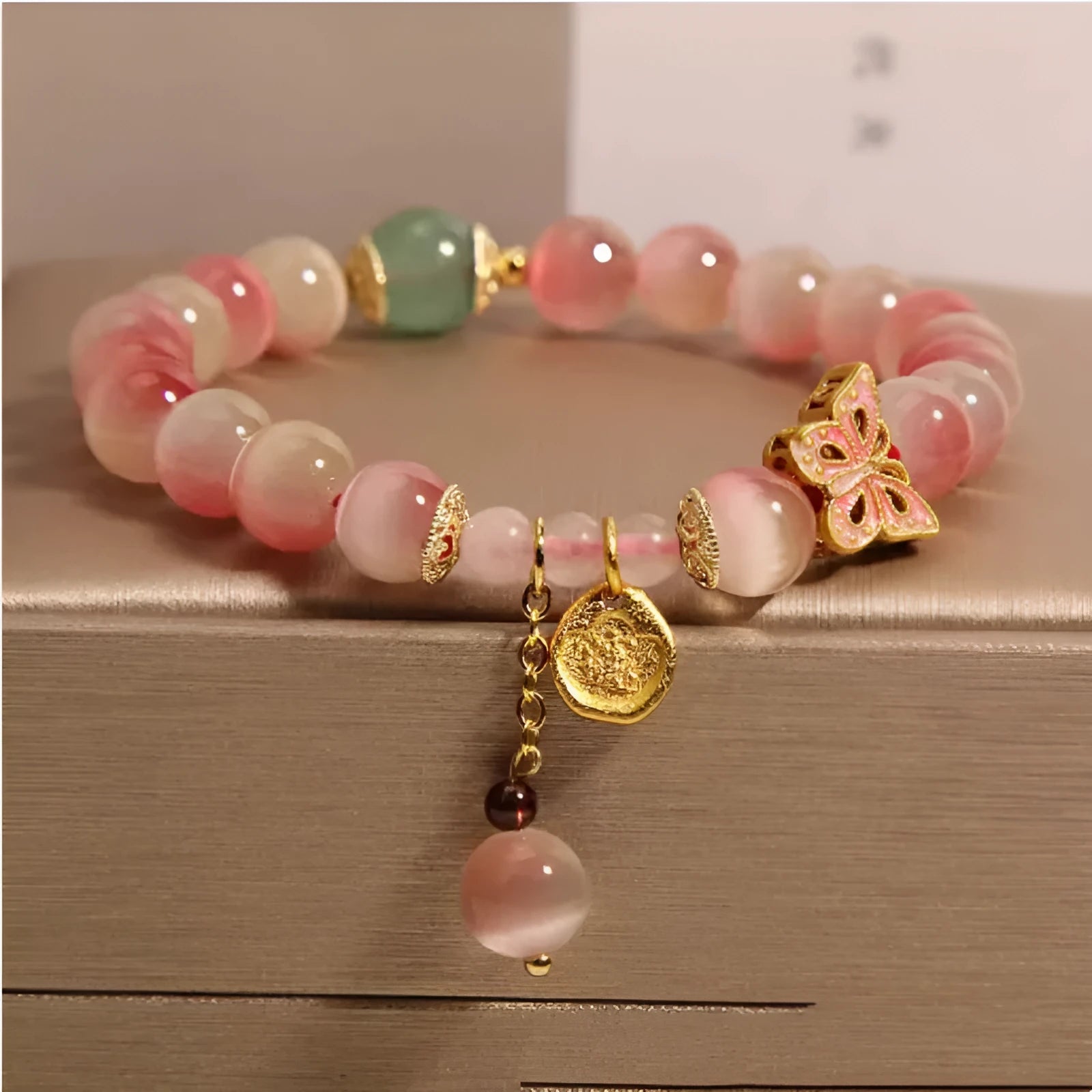 Pink opal butterfly women's bracelet with electroplated finish, Chinese style, on display