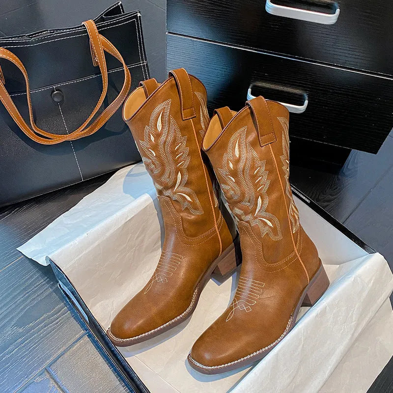 Brown women's embroidered mid-calf Martin boots on a white background, showing round toe and low square heel.