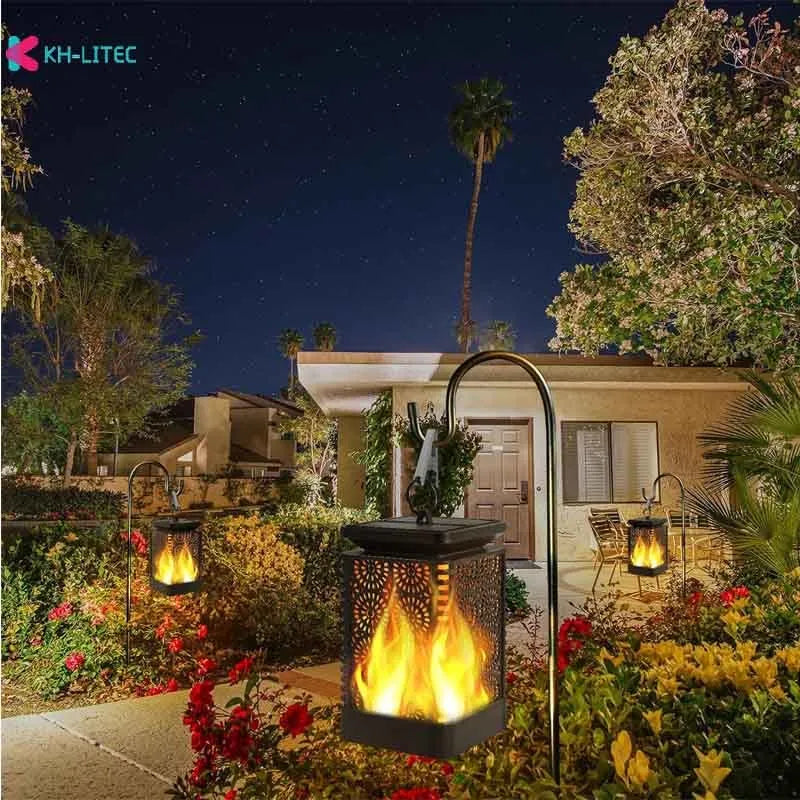 Black solar-powered LED hanging torch light with flickering flame effect for outdoor garden decoration.