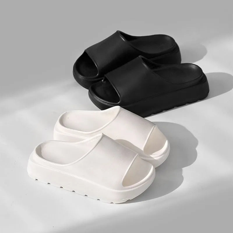 Women's beige fish mouth slippers with a thick 5.5cm light-coloured EVA sole on a wooden floor.