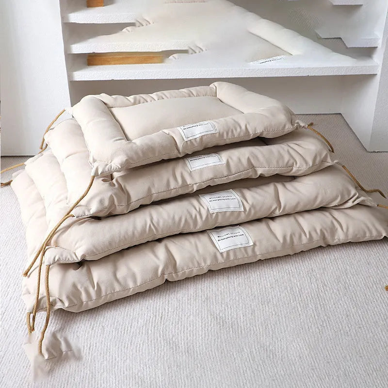 Beige cage cushion tied in a wire dog crate with soft padding for small pets