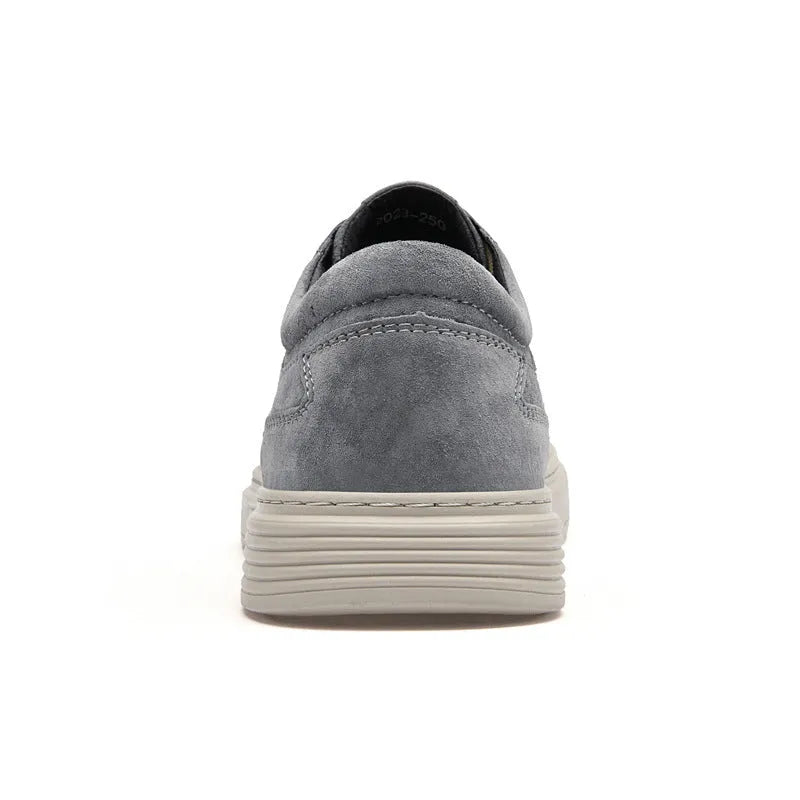 Men's grey low-top casual skate shoes with a pigskin leather upper and rubber sole.
