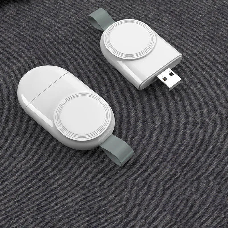 Portable wireless Apple Watch charging dock in white on a desk, with USB cable attached