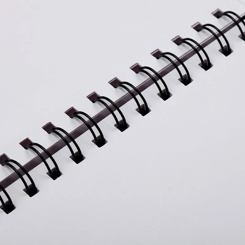 A4 coil-bound sketchbook with blank pages and 160g paper, open on a table