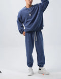 Men's loose fit polar fleece sports suit in winter colours, showing coat and trousers.