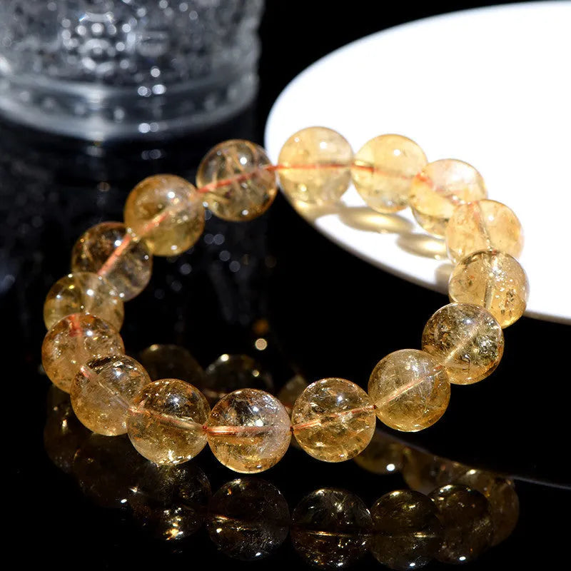 Natural yellow citrine bead bracelet showing geometric Asestelle cutting in both single and three-circle configurations