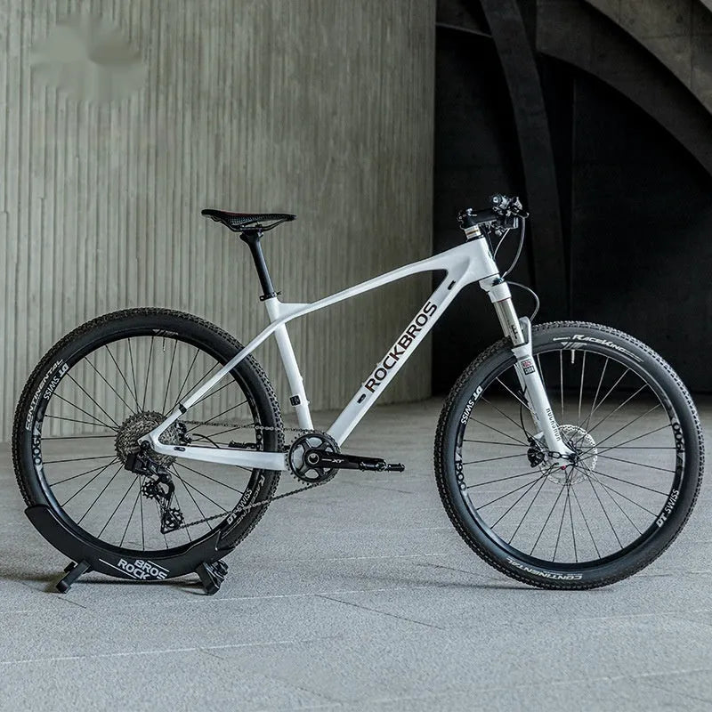 ABS wall-mounted bike parking rack holder in black holding a bicycle frame against a garage wall