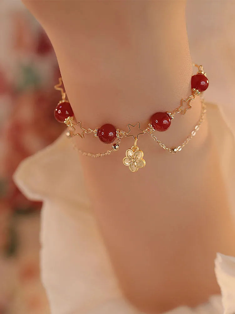 Red agate double layer bracelet with peach blossom decoration on female wrist