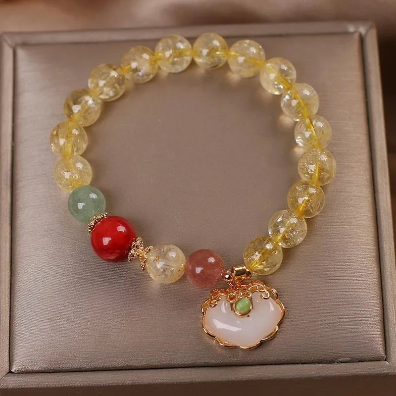 Women's yellow hair crystal jade ruyi pendant bracelet on an alloy chain.