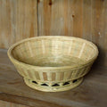 Handmade natural bamboo storage basket shown in one of three available sizes.