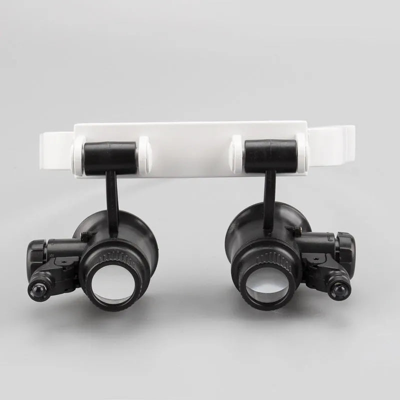 White head-mounted magnifying glass with LED light, shown folded and unfolded, for watch and circuit board repair.