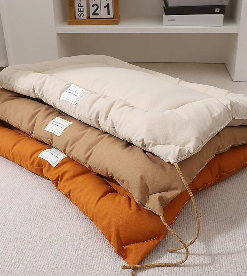 Beige cage cushion tied in a wire dog crate with soft padding for small pets
