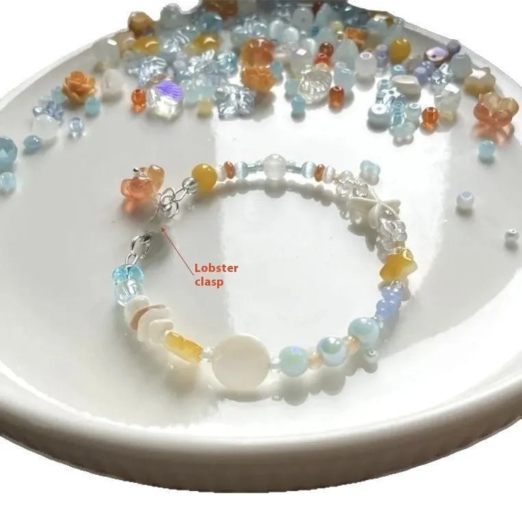 Orange seaside bracelet for women with diamond-shaped charm and round decorative elements on mixed material band