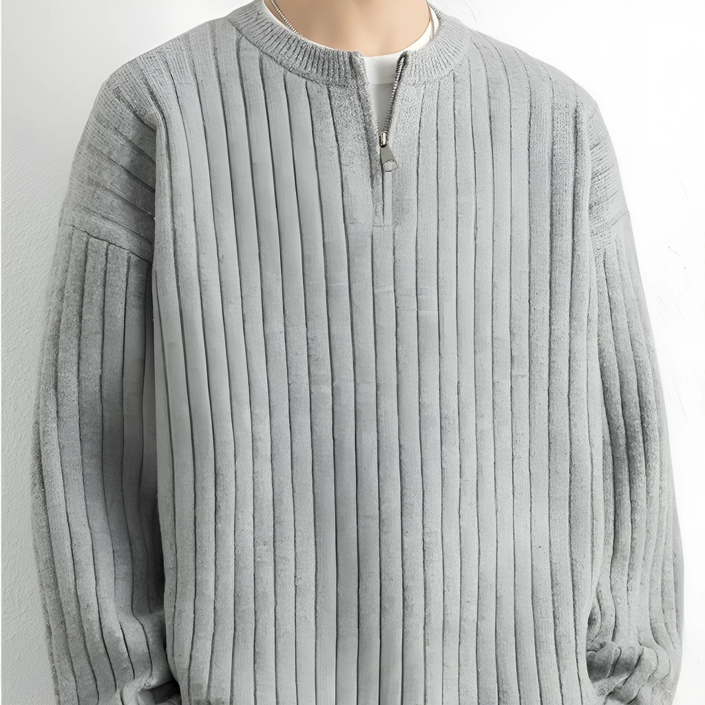 Men's loose grey half zip sweater with textured knit and long sleeves.