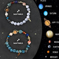 Two natural stone beaded bracelets with zodiac sign charms on a wooden surface.