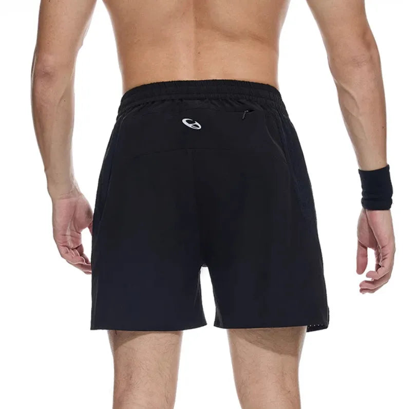 Black running shorts with laser stitching detail on a grey background.