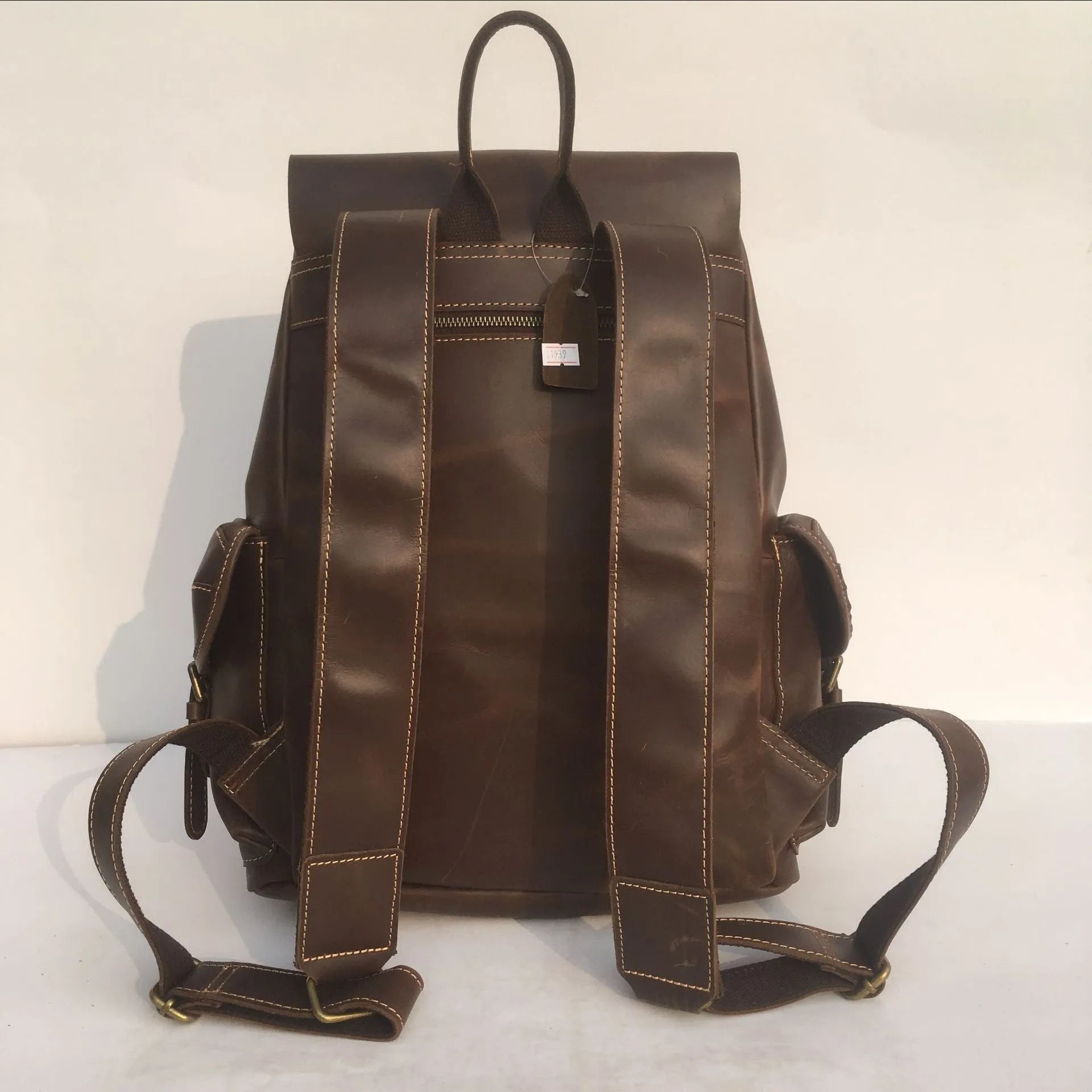 Men's genuine top layer cowhide leather backpack in coffee brown with air pillow belt, front view