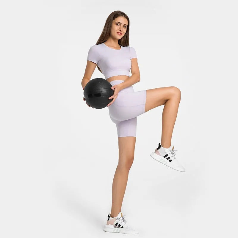 Women's tight-fitting mid-thigh sports shorts in grey lake green for fitness.