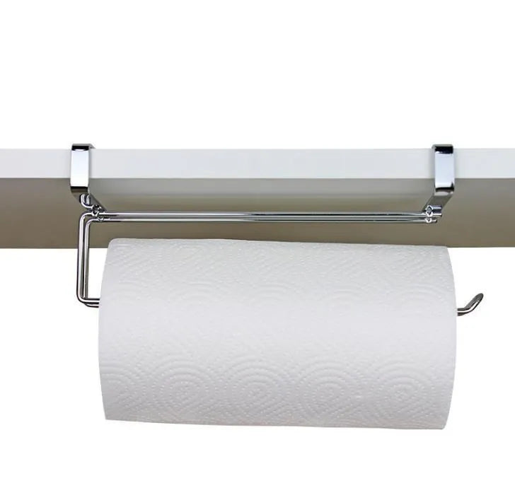 Silver stainless steel paper towel rack hanging on the back of a kitchen cabinet door.