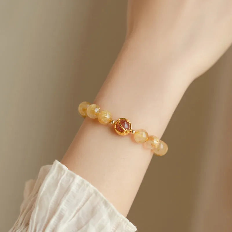 Natural citrine gold rutilated quartz diamond cut bracelet 6mm beads on neutral background