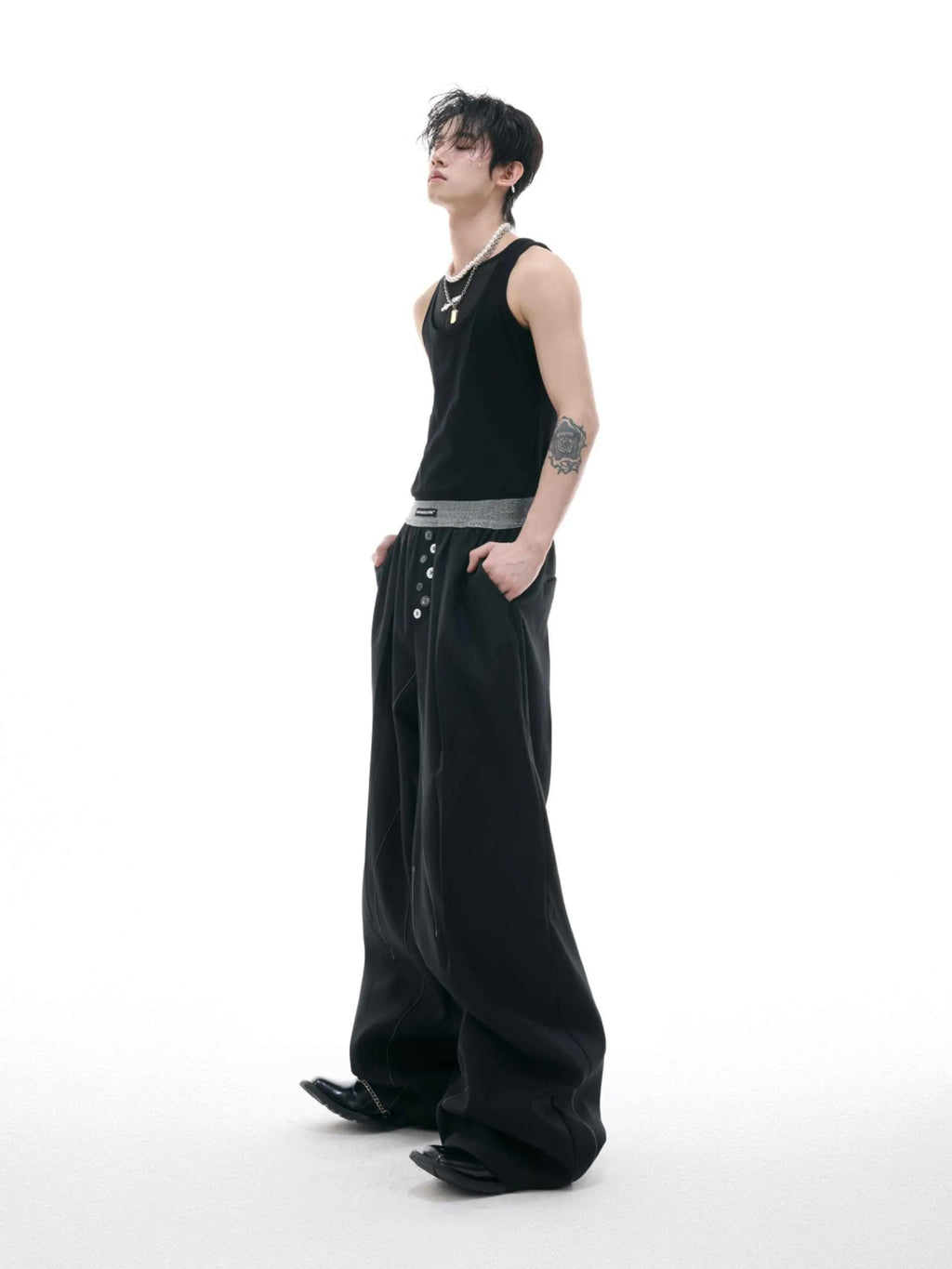 Drooping straight-leg high-waisted casual trousers with button detail in black and grey.