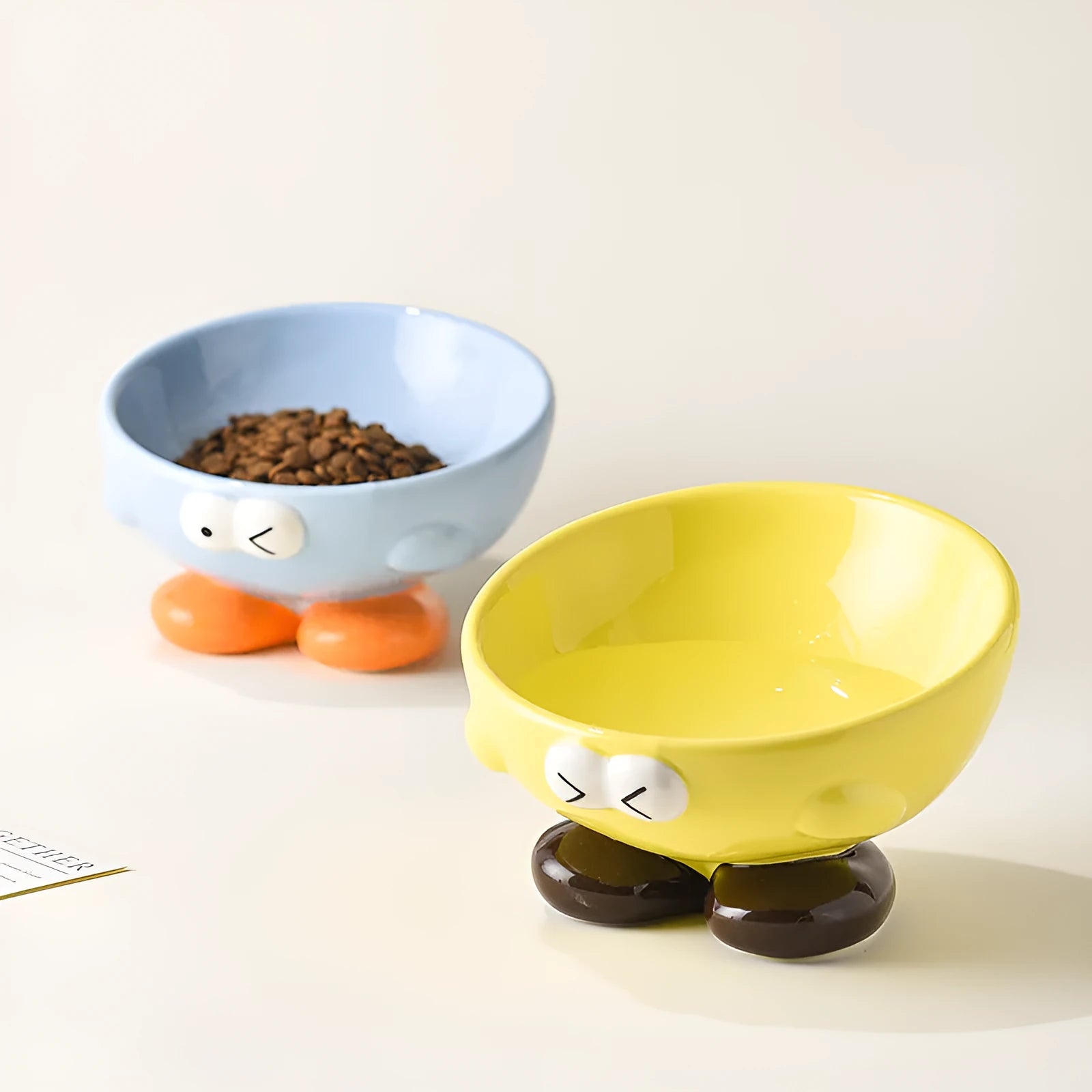 Oblique ceramic cat food bowl with cute expression print in blue for cervical spine protection