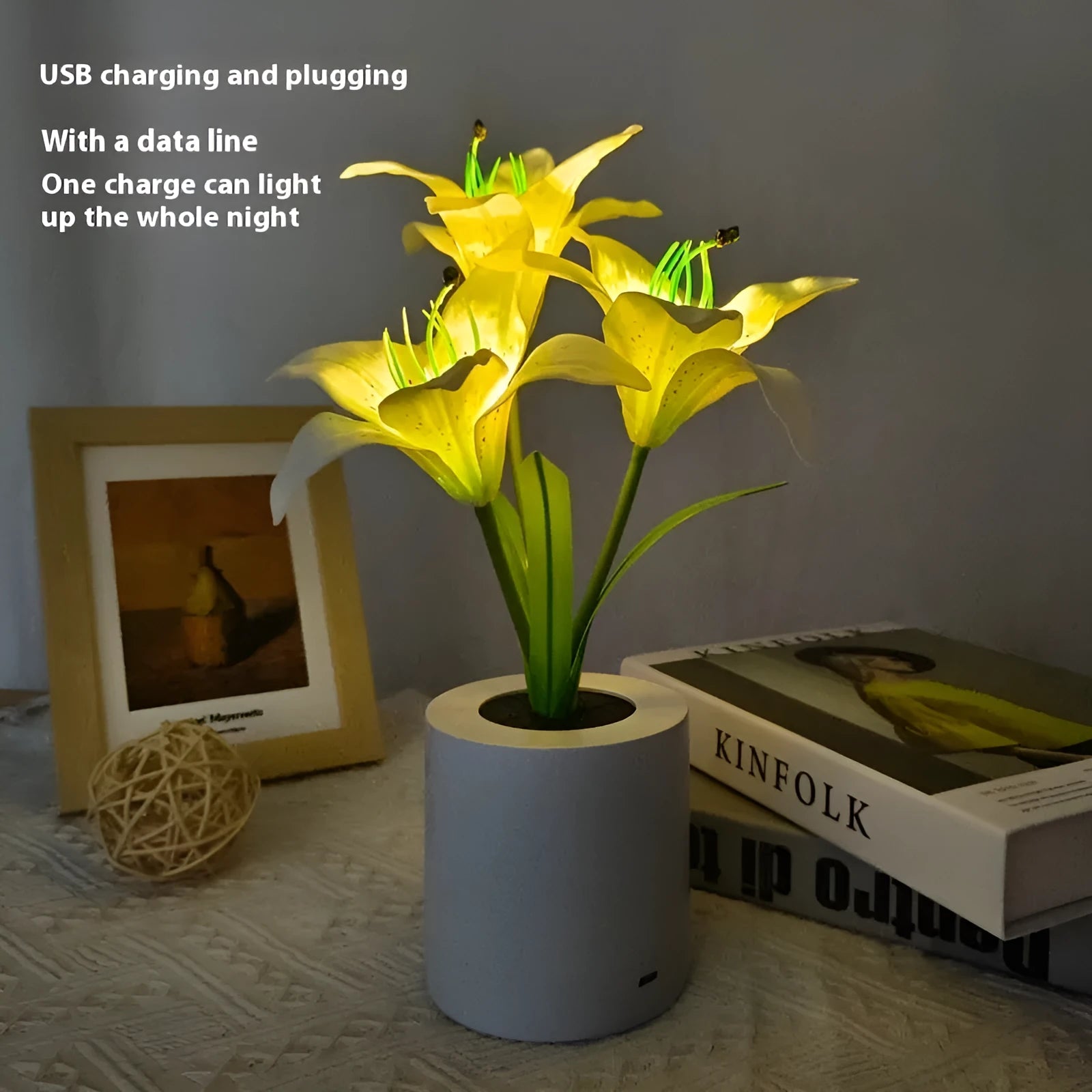 Rechargeable LED lily flower pot lamp in lily-pink colour, flower shape, on tabletop
