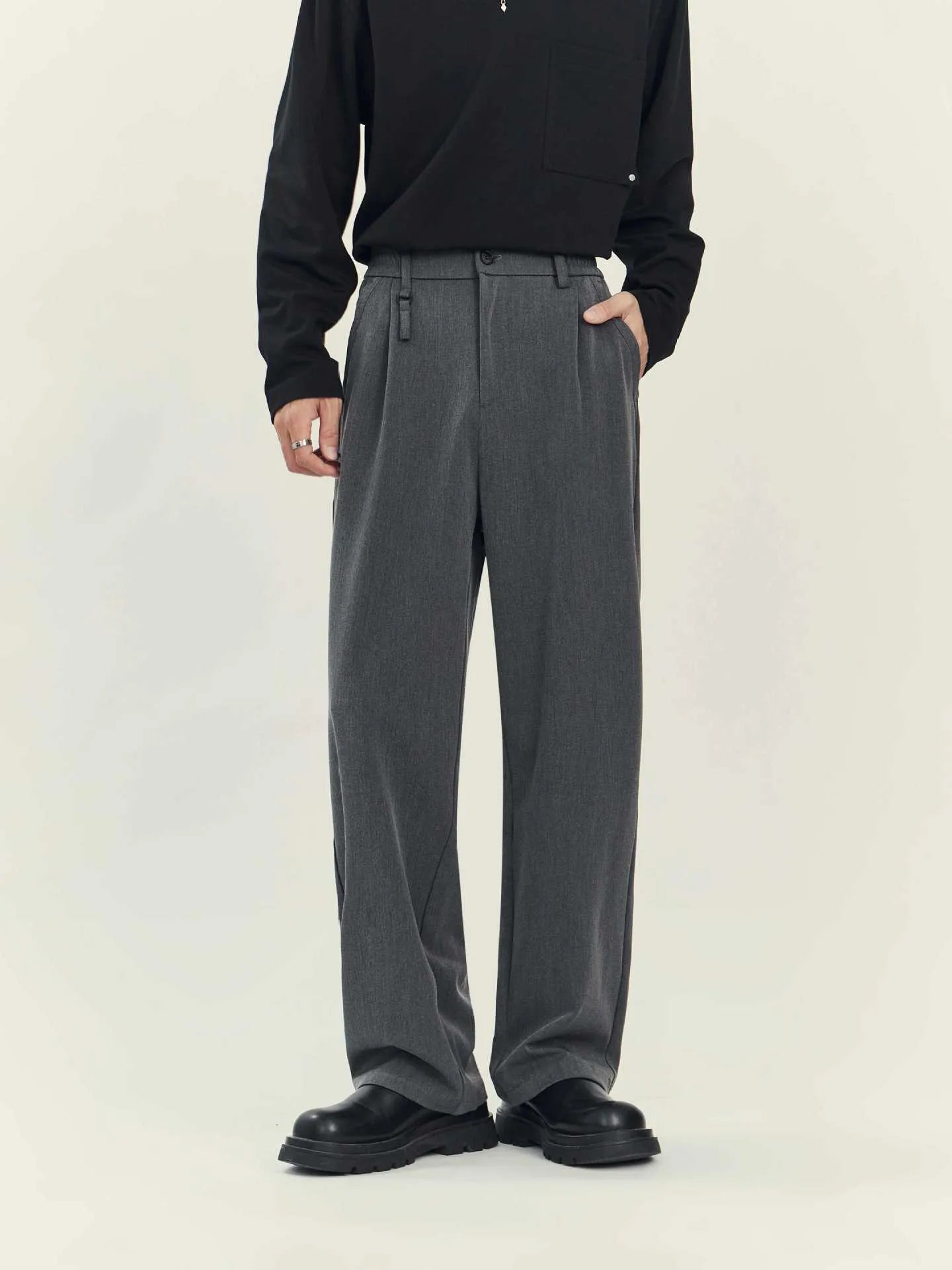 Business casual draping suit pants in black with loose straight leg and solid colour design