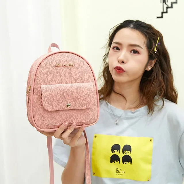 Women's small PU shoulder backpack in solid colour with convertible strap design and zipper closure