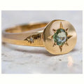Gold coloured adjustable ring with a star-shaped zircon centre on a zinc alloy band.