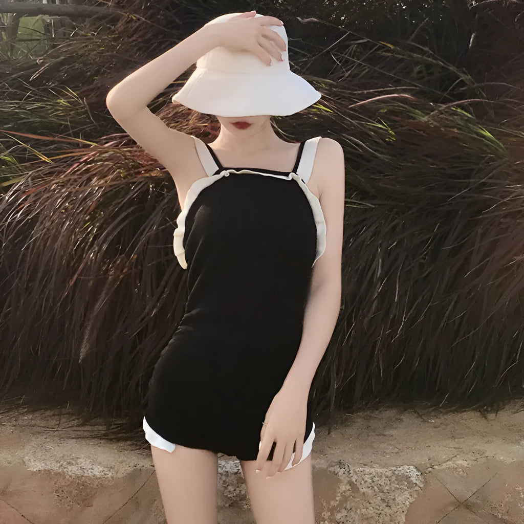 Women's conservative one-piece swimsuit in black with white edge, nylon fabric, size L