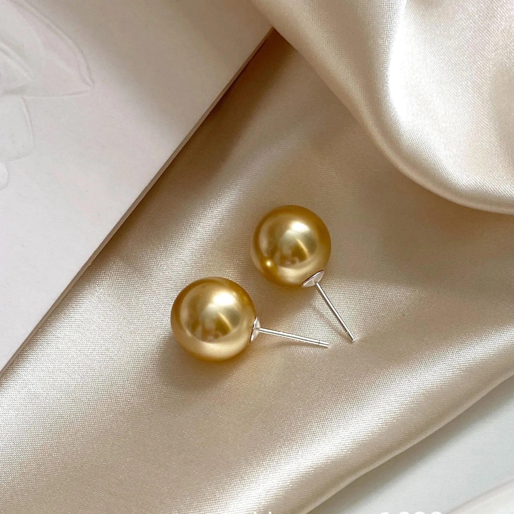 Large geometric pearl stud earrings with retro styling and eight-point star detail in silver