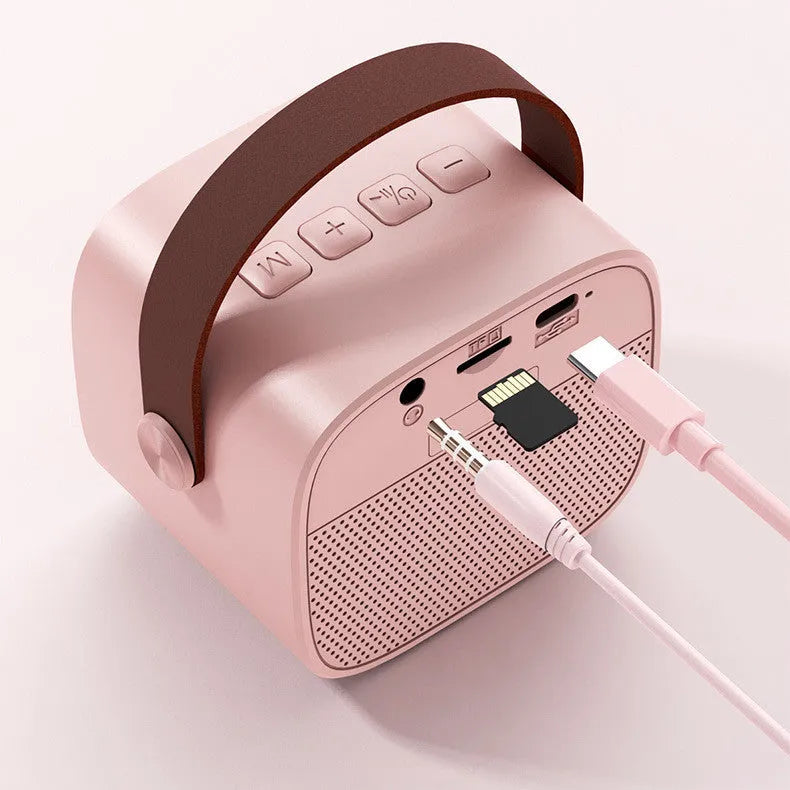 Wireless Bluetooth portable speaker with microphone in plastic shell, available in white pink and blue, with USB charging