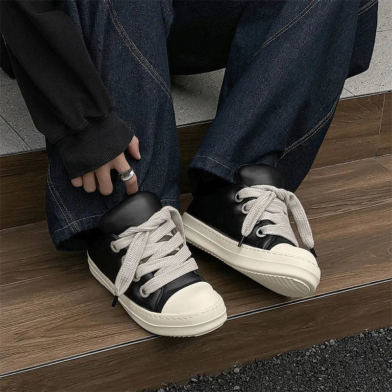 Men's black leather low-top slip-on casual shoes with raised bottom board, round toe, and front lace-up