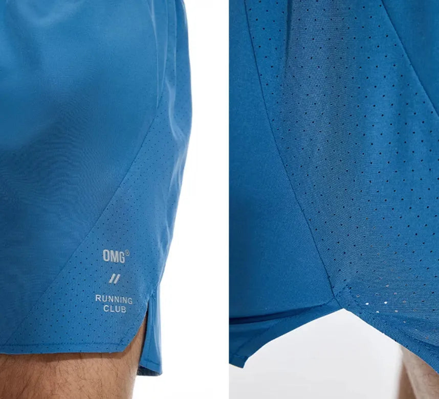Black running shorts with laser stitching detail on a grey background.