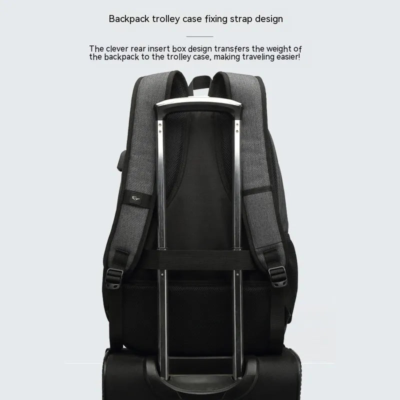 Gray USB charging backpack with luggage strap on a trolley case, showing charging port.