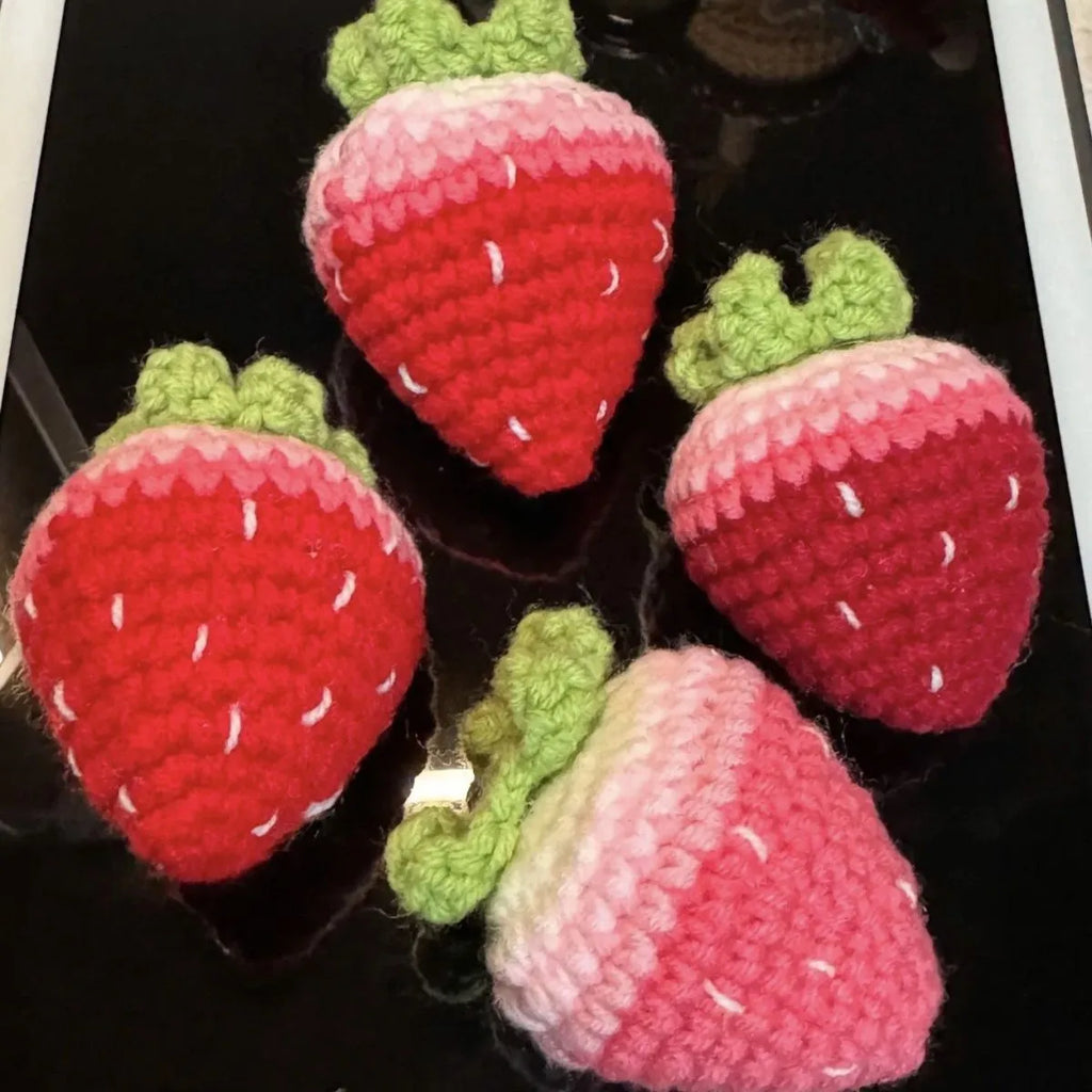 Plush strawberry pendant keychain in pink with metal ring on a white background