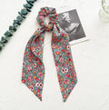 Women's cloth hair band with long ribbon and large intestine ring design in dark green colour