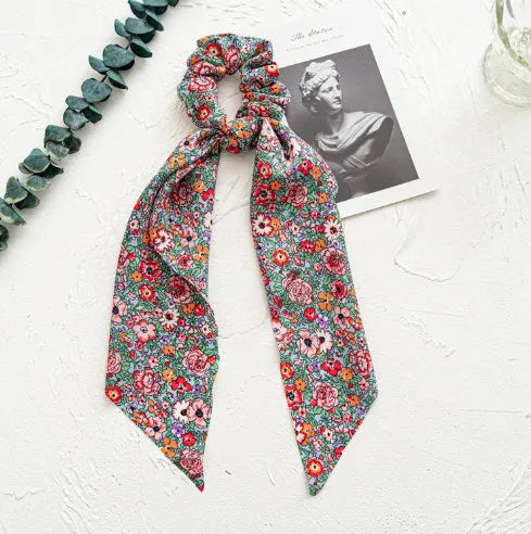Women's cloth hair band with long ribbon and large intestine ring design in dark green colour