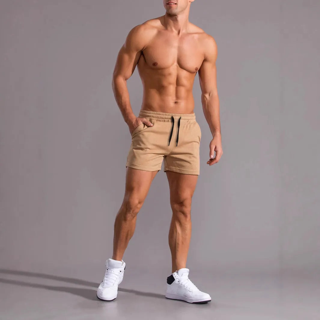Pack of three men's casual drawstring shorts in black, khaki, and light brown colours laid flat.