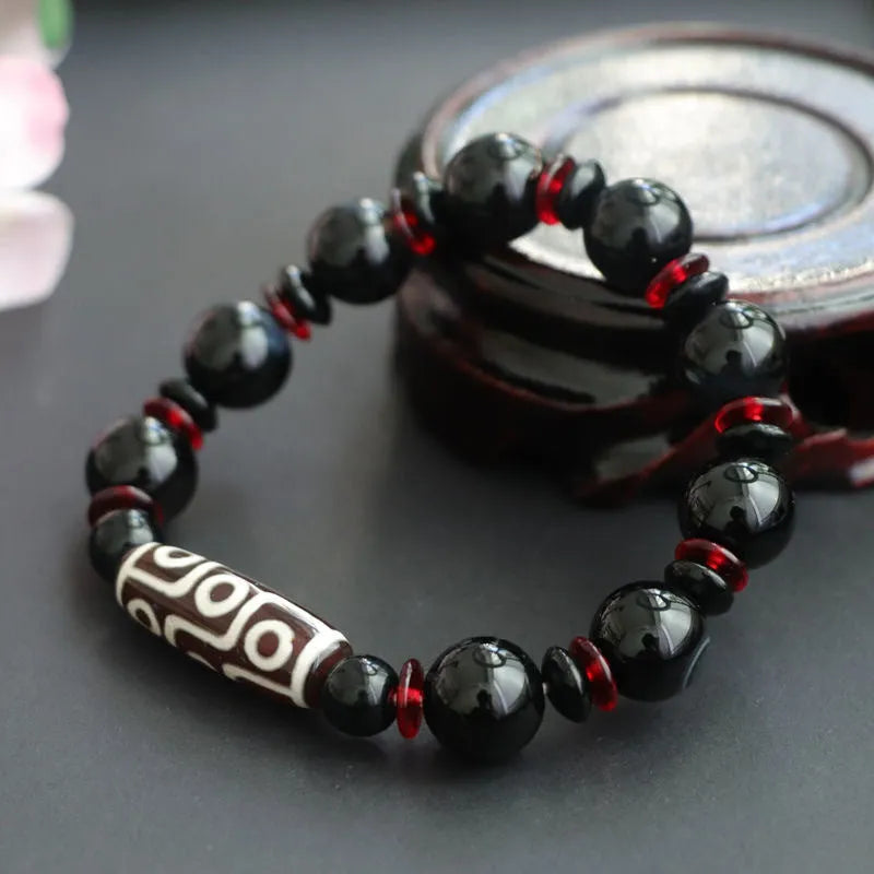 Black agate Dzi bead bracelet with geometric design and hand-woven construction