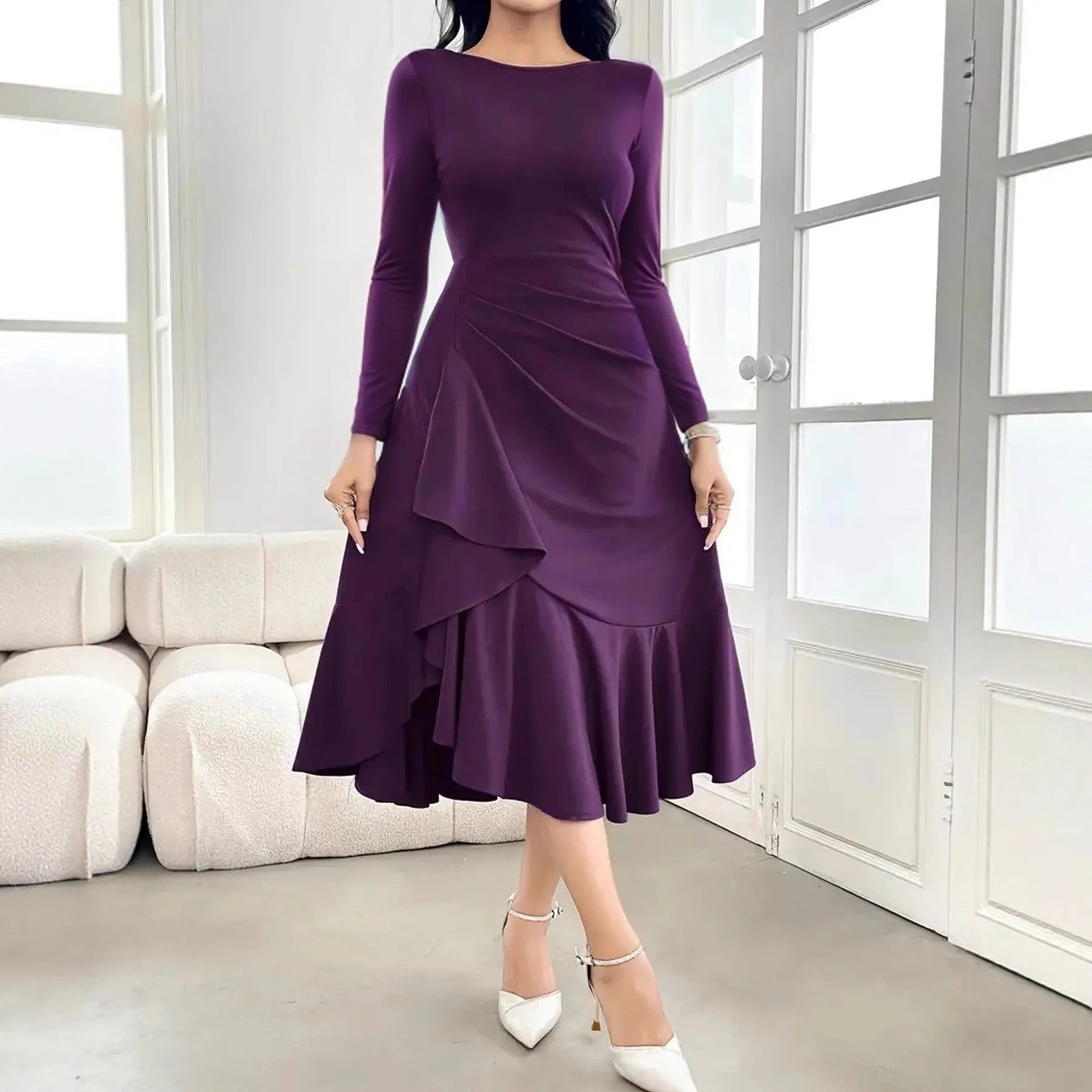 Purple women's dress with ruffled detailing, long sleeves and round neckline on mannequin