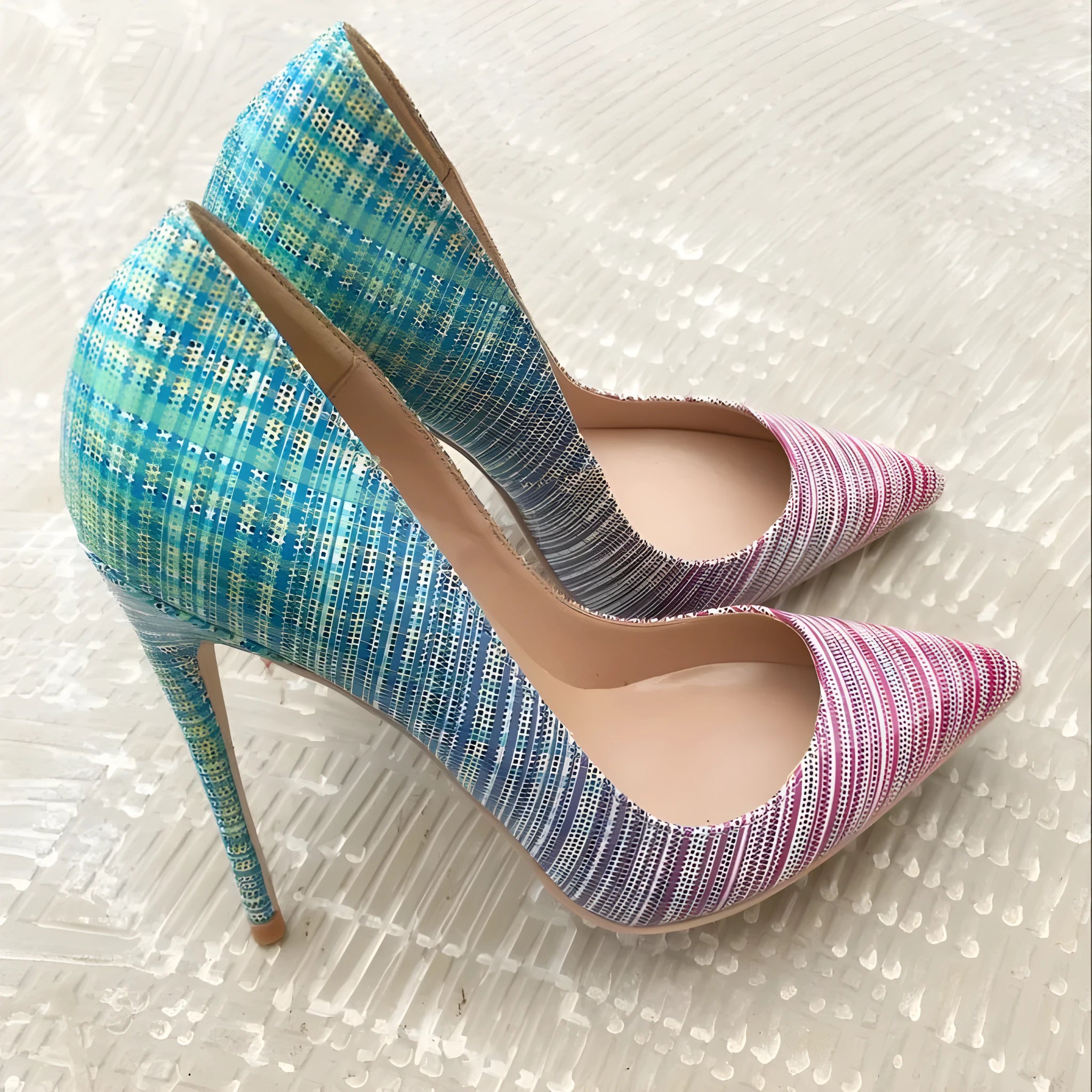 Ladies pink and blue gradient patent leather pointed toe high heels on a white background
