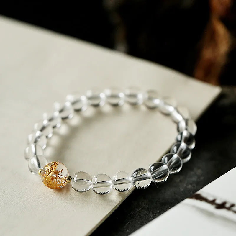 Unisex obsidian black agate and white crystal beaded bracelet on a neutral background, 10mm and 8mm beads