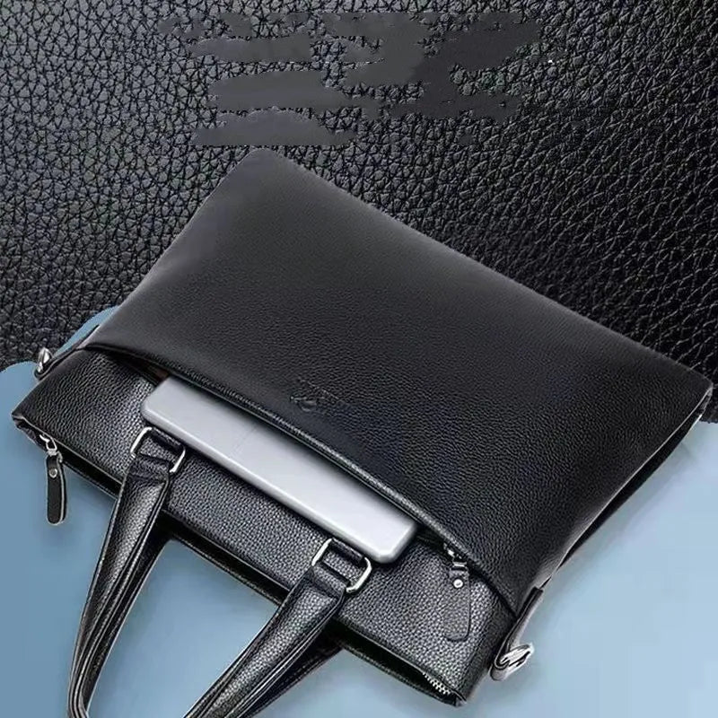 Men's black PU leather crossbody messenger bag with splicing design, shown next to a tablet for scale.