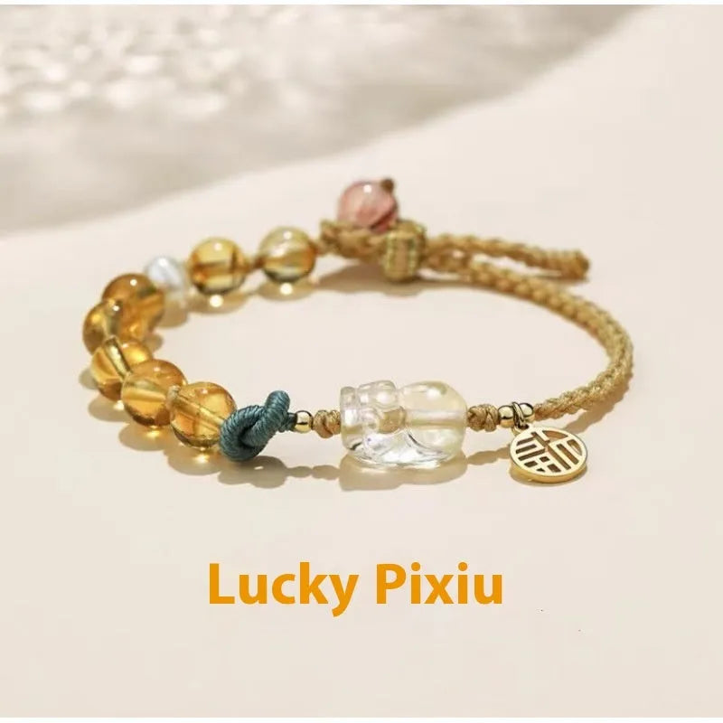 Hand-woven citrine crystal bracelet with zodiac design on neutral background