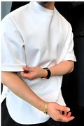 White men's T-shirt with a buttoned round hem and boxy fit on a plain background.