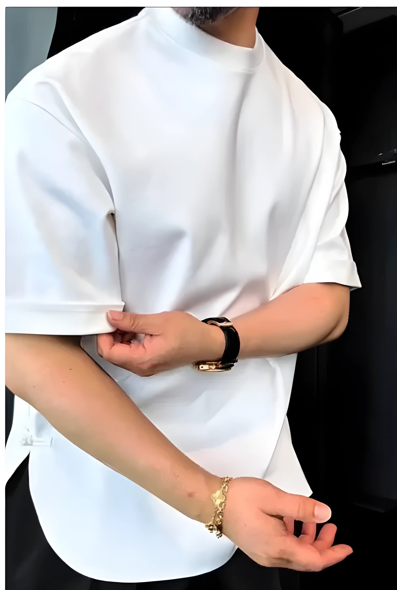 White men's T-shirt with a buttoned round hem and boxy fit on a plain background.